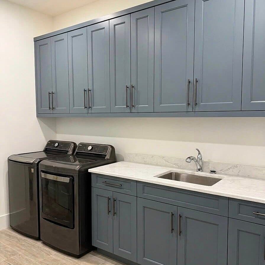 Blue-gray Shaker laundry room with quartz counter
