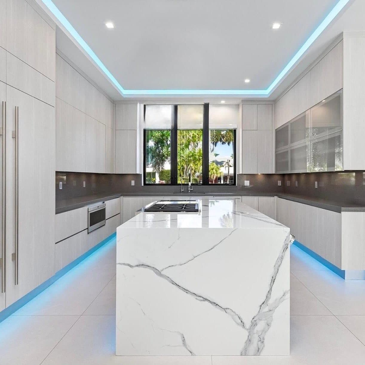 Melamine kitchen with LED accent lighting and waterfall island