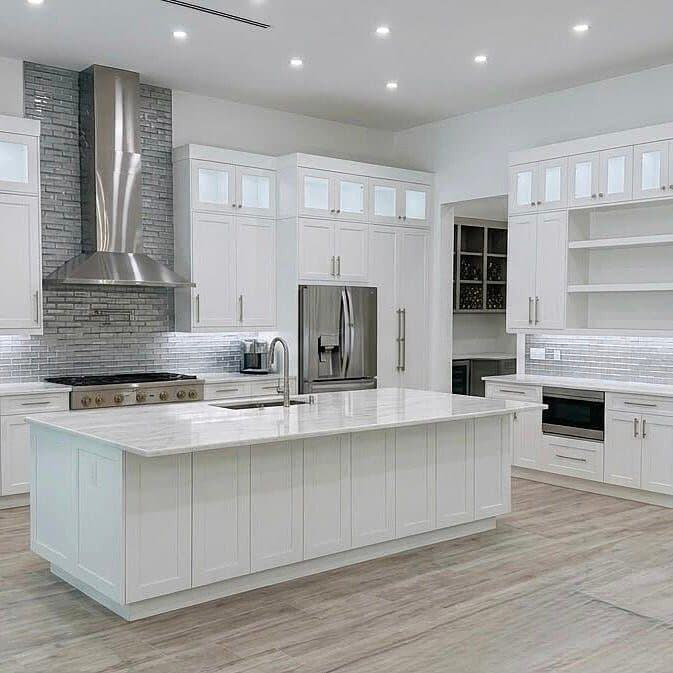 White Shaker luxury kitchen with island and stainless hood